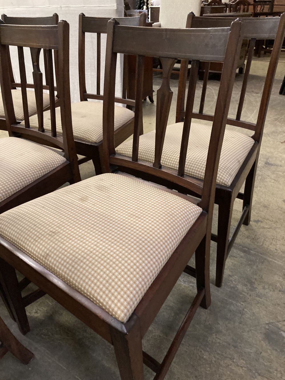 A set of eight late George III mahogany dining chairs, two with arms, six single